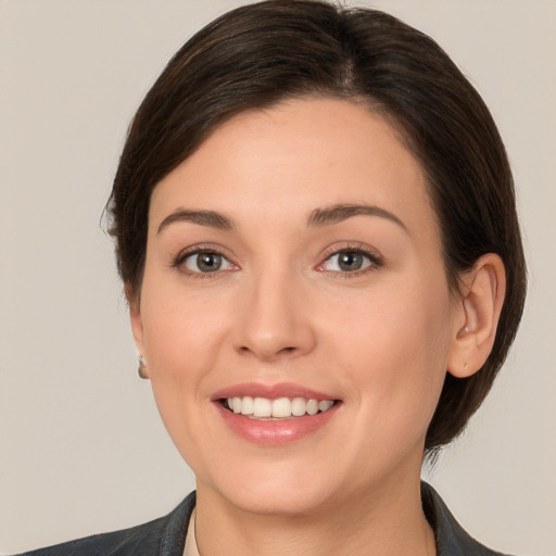 Joyful white young-adult female with medium  brown hair and brown eyes