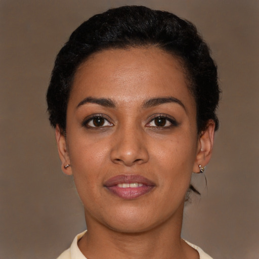 Joyful black young-adult female with short  brown hair and brown eyes