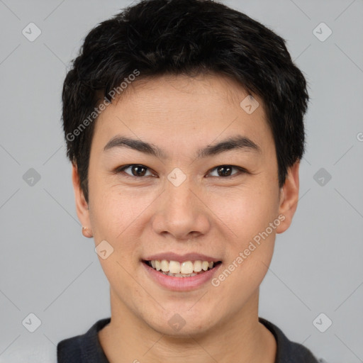 Joyful asian young-adult male with short  brown hair and brown eyes