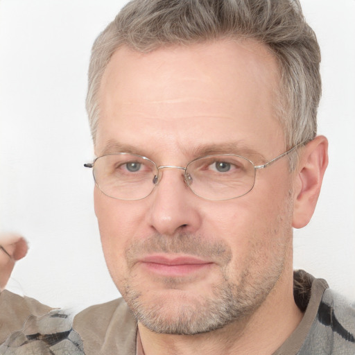 Joyful white adult male with short  brown hair and blue eyes