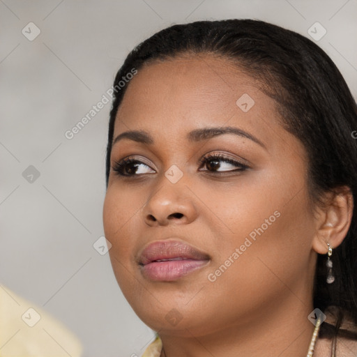 Joyful black young-adult female with long  brown hair and brown eyes