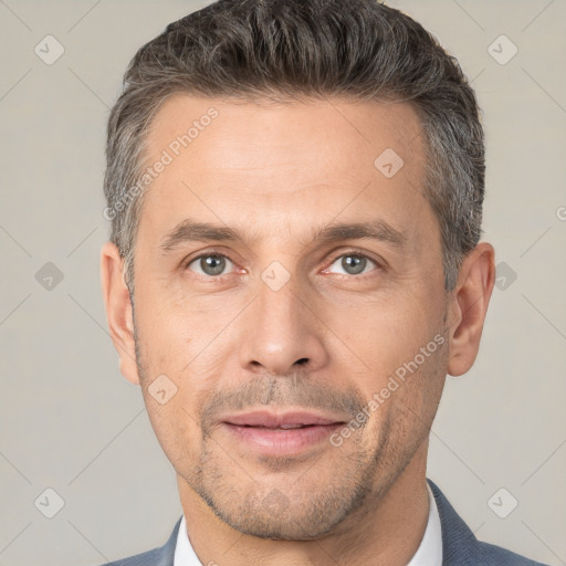 Joyful white adult male with short  brown hair and brown eyes