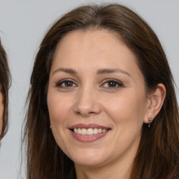 Joyful white adult female with long  brown hair and brown eyes