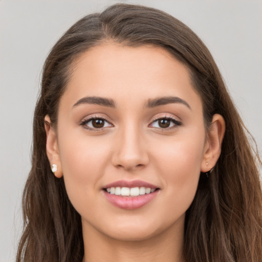 Joyful white young-adult female with long  brown hair and brown eyes