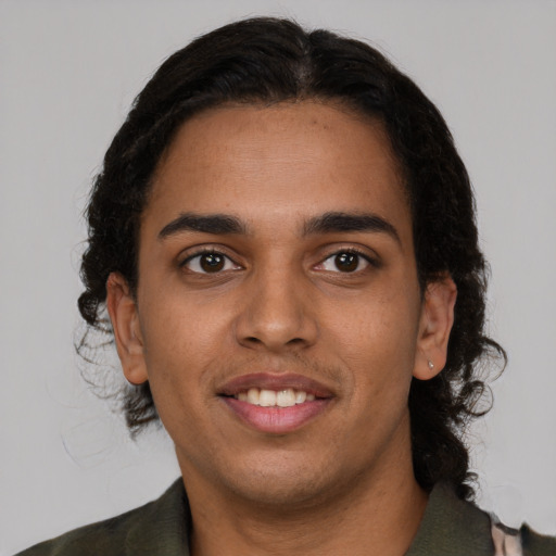 Joyful latino young-adult male with medium  brown hair and brown eyes