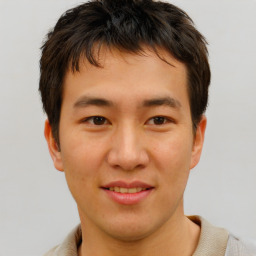 Joyful asian young-adult male with short  brown hair and brown eyes