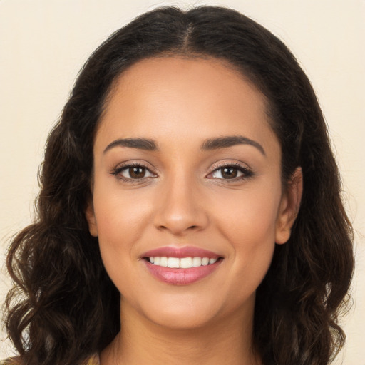 Joyful latino young-adult female with long  brown hair and brown eyes