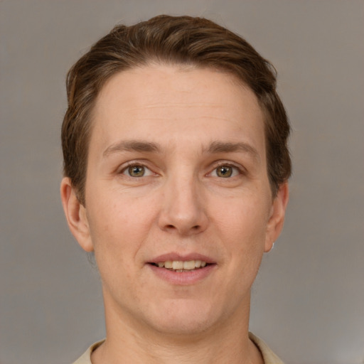 Joyful white adult male with short  brown hair and grey eyes