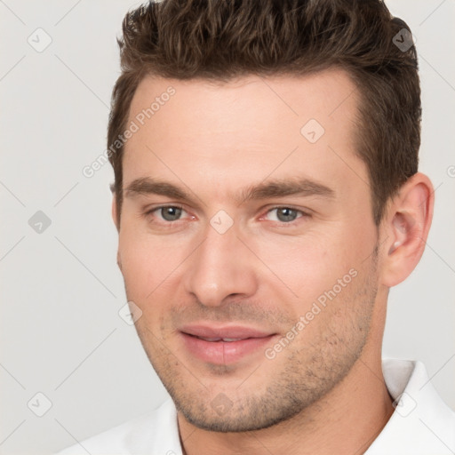 Joyful white young-adult male with short  brown hair and brown eyes