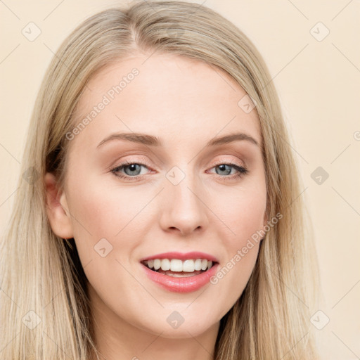 Joyful white young-adult female with long  brown hair and blue eyes