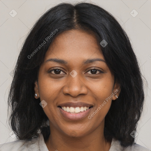 Joyful black young-adult female with long  black hair and brown eyes