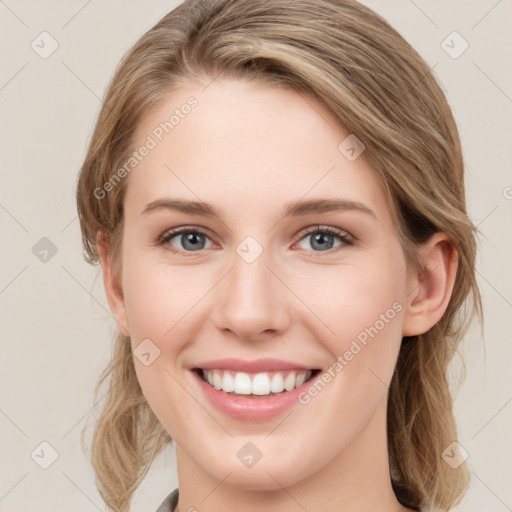 Joyful white young-adult female with medium  brown hair and blue eyes