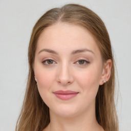 Joyful white young-adult female with long  brown hair and green eyes