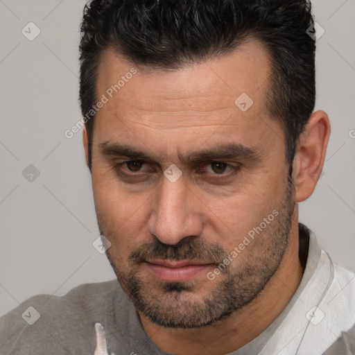 Joyful white adult male with short  brown hair and brown eyes