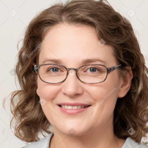 Joyful white adult female with medium  brown hair and blue eyes