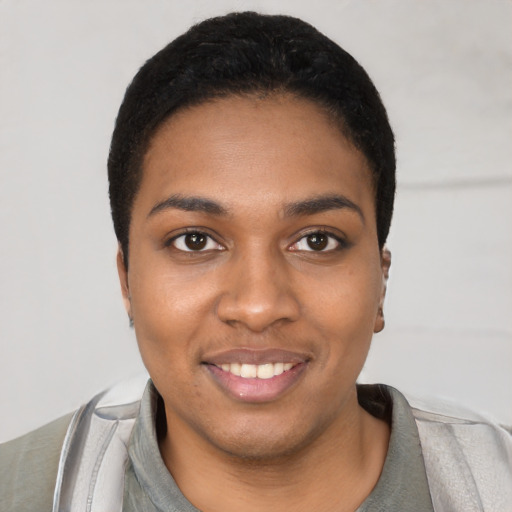 Joyful black young-adult female with short  black hair and brown eyes