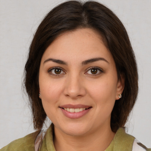 Joyful white young-adult female with medium  brown hair and brown eyes