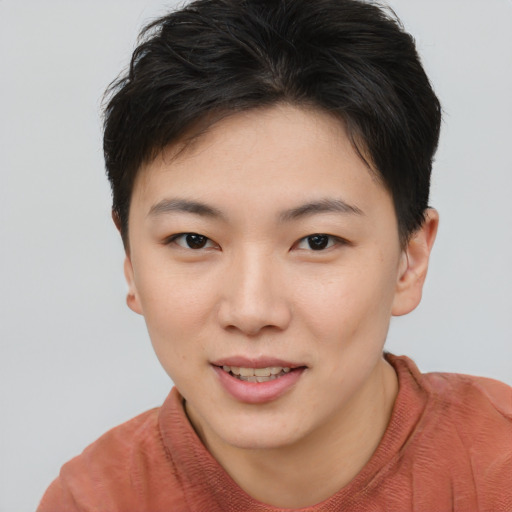 Joyful asian young-adult female with short  brown hair and brown eyes