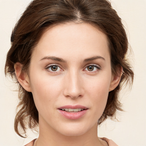 Joyful white young-adult female with medium  brown hair and green eyes