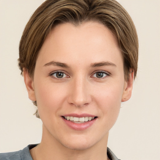 Joyful white young-adult female with short  brown hair and grey eyes