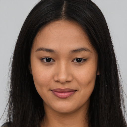 Joyful asian young-adult female with long  brown hair and brown eyes