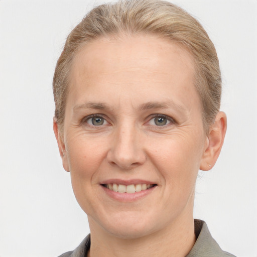 Joyful white adult female with short  brown hair and grey eyes