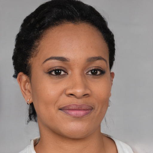 Joyful black young-adult female with short  brown hair and brown eyes