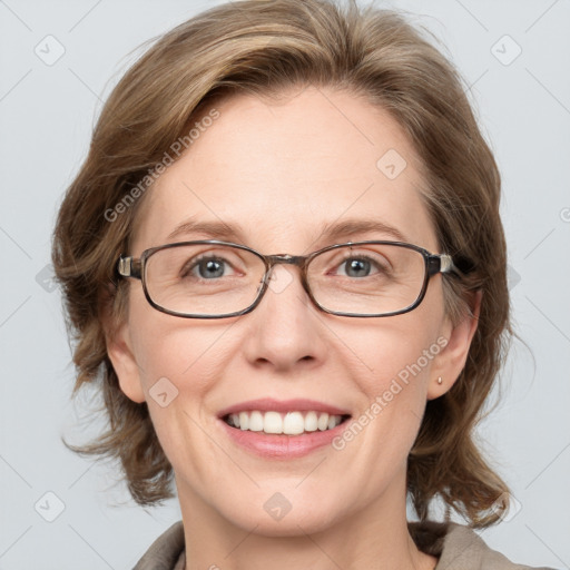 Joyful white adult female with medium  brown hair and blue eyes