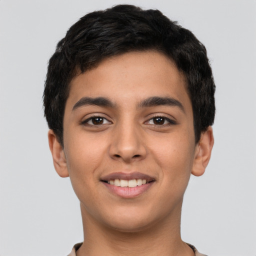 Joyful latino young-adult male with short  black hair and brown eyes