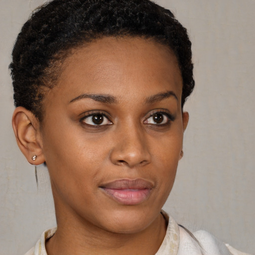 Joyful black young-adult female with short  brown hair and brown eyes