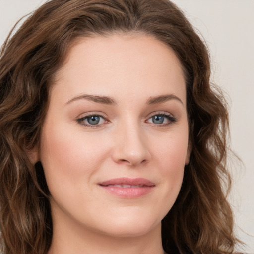 Joyful white young-adult female with long  brown hair and green eyes