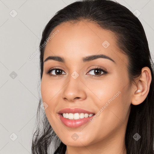 Joyful white young-adult female with long  black hair and brown eyes