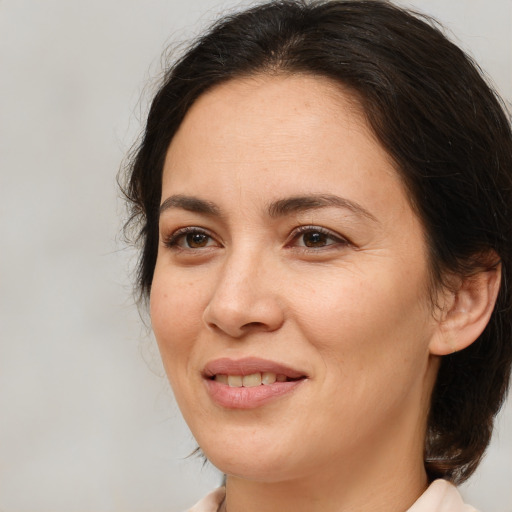 Joyful white adult female with medium  brown hair and brown eyes