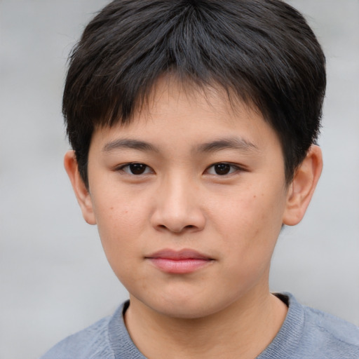 Joyful asian child male with short  brown hair and brown eyes
