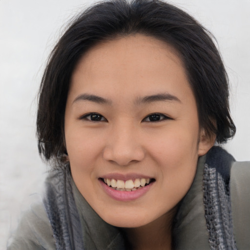 Joyful asian young-adult female with long  brown hair and brown eyes