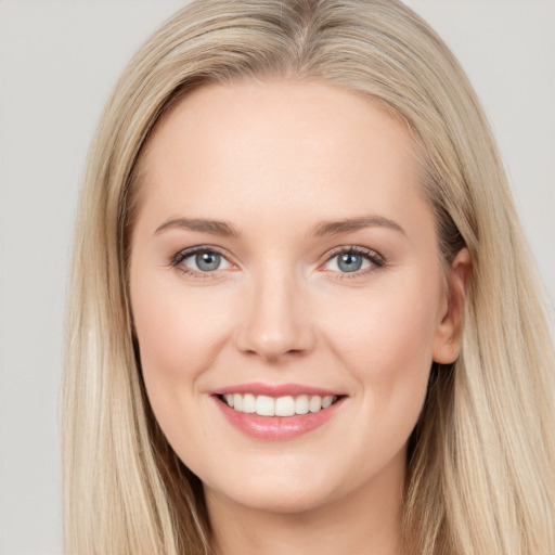 Joyful white young-adult female with long  brown hair and blue eyes