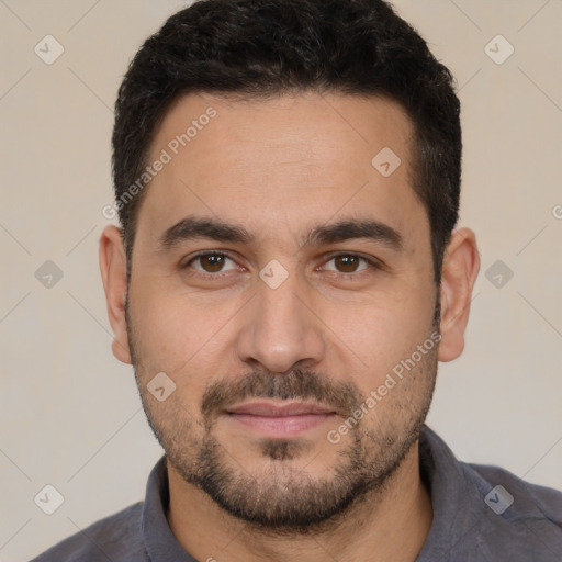 Joyful white young-adult male with short  black hair and brown eyes