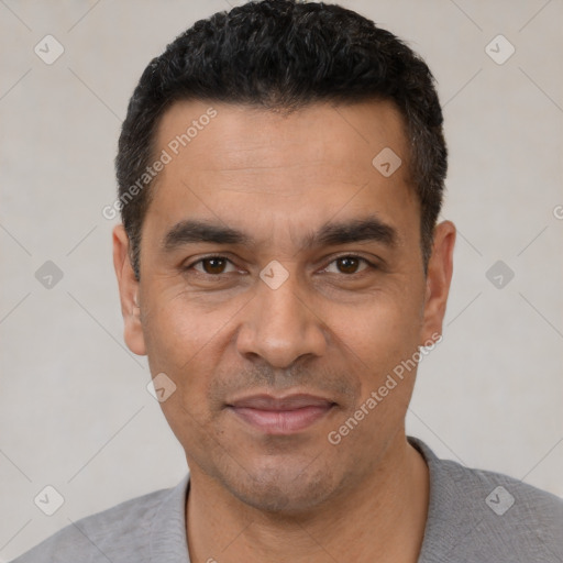 Joyful latino adult male with short  black hair and brown eyes