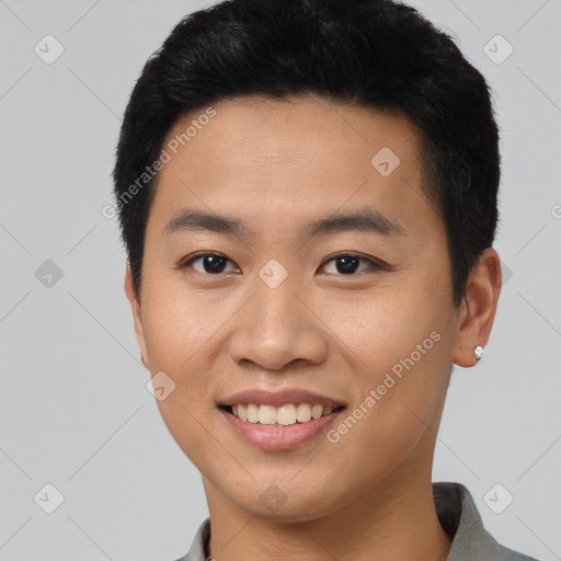 Joyful asian young-adult male with short  black hair and brown eyes