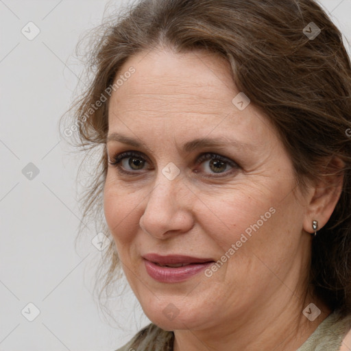 Joyful white adult female with medium  brown hair and grey eyes