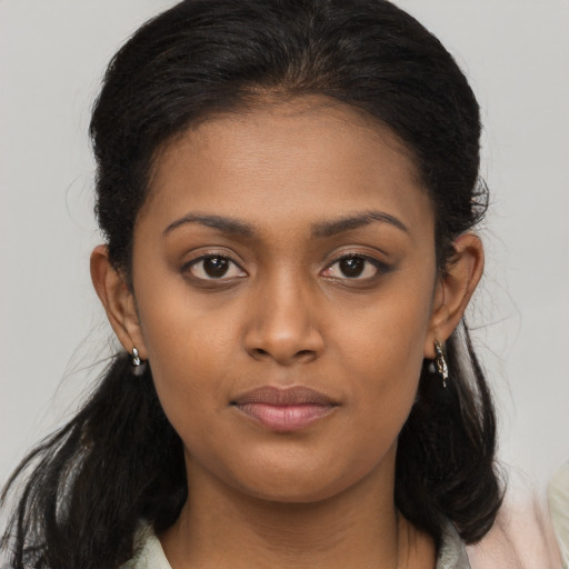 Joyful latino young-adult female with long  brown hair and brown eyes