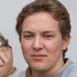 Joyful white adult female with medium  brown hair and blue eyes