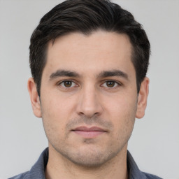 Neutral white young-adult male with short  black hair and brown eyes
