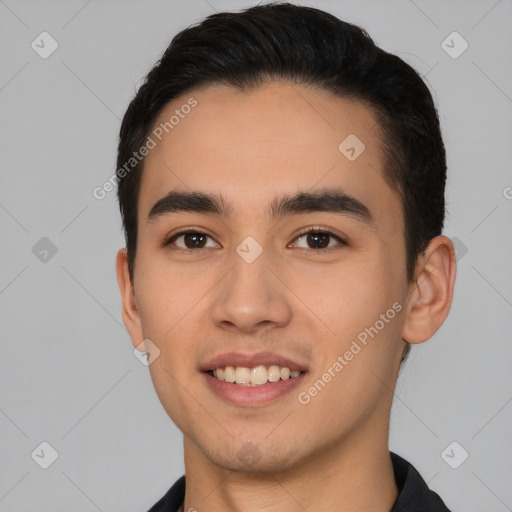 Joyful white young-adult male with short  black hair and brown eyes