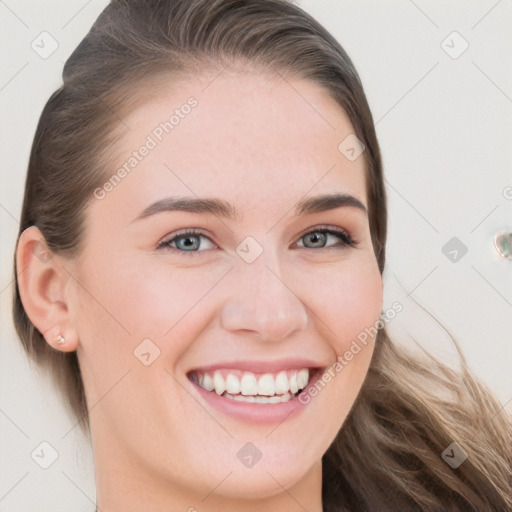 Joyful white young-adult female with long  brown hair and blue eyes