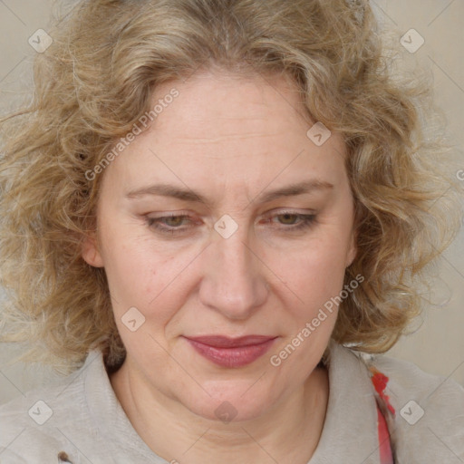 Joyful white adult female with medium  brown hair and blue eyes