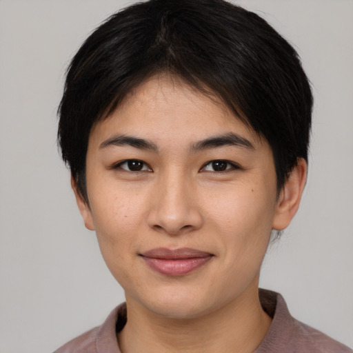 Joyful asian young-adult female with short  brown hair and brown eyes