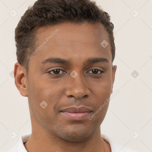 Joyful black young-adult male with short  brown hair and brown eyes