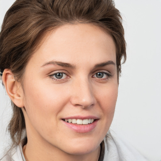 Joyful white young-adult female with medium  brown hair and grey eyes