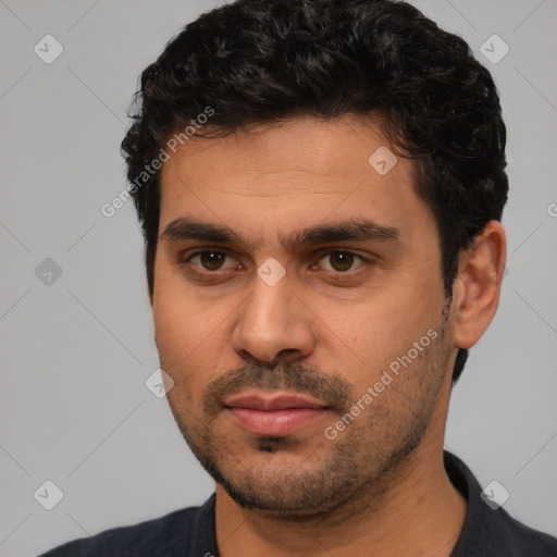 Joyful white young-adult male with short  black hair and brown eyes